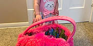 Ariah is registered to the contest to win money with this photo: toddler, child, pink_dress, bow, hair_accessory, smiling, indoor, carpet, door, toy_bag, fuzzy, plush, happy, person, cute, small_child, playful, colorful, clothing, floor