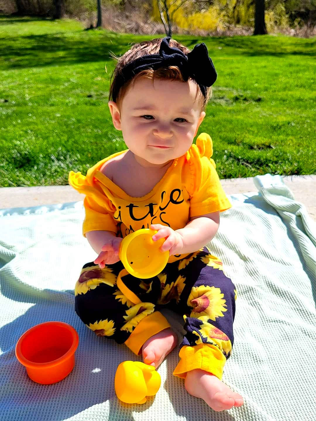 Elyse joined the competition — help win amazing prizes! baby, baby_toddler_clothing, bucket, child, eyewear, fun, grass, happy, head, headwear, leisure, person, personal_protective_equipment, plant, play, recreation, sitting, t_shirt, toddler, tree