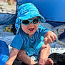 baby, beach, blanket, blue_hat, child, clothing, cute, face, feet, happy, headwear, infant, outdoor, playful, sitting, smiling, summer, sunglasses, sunlight, tent