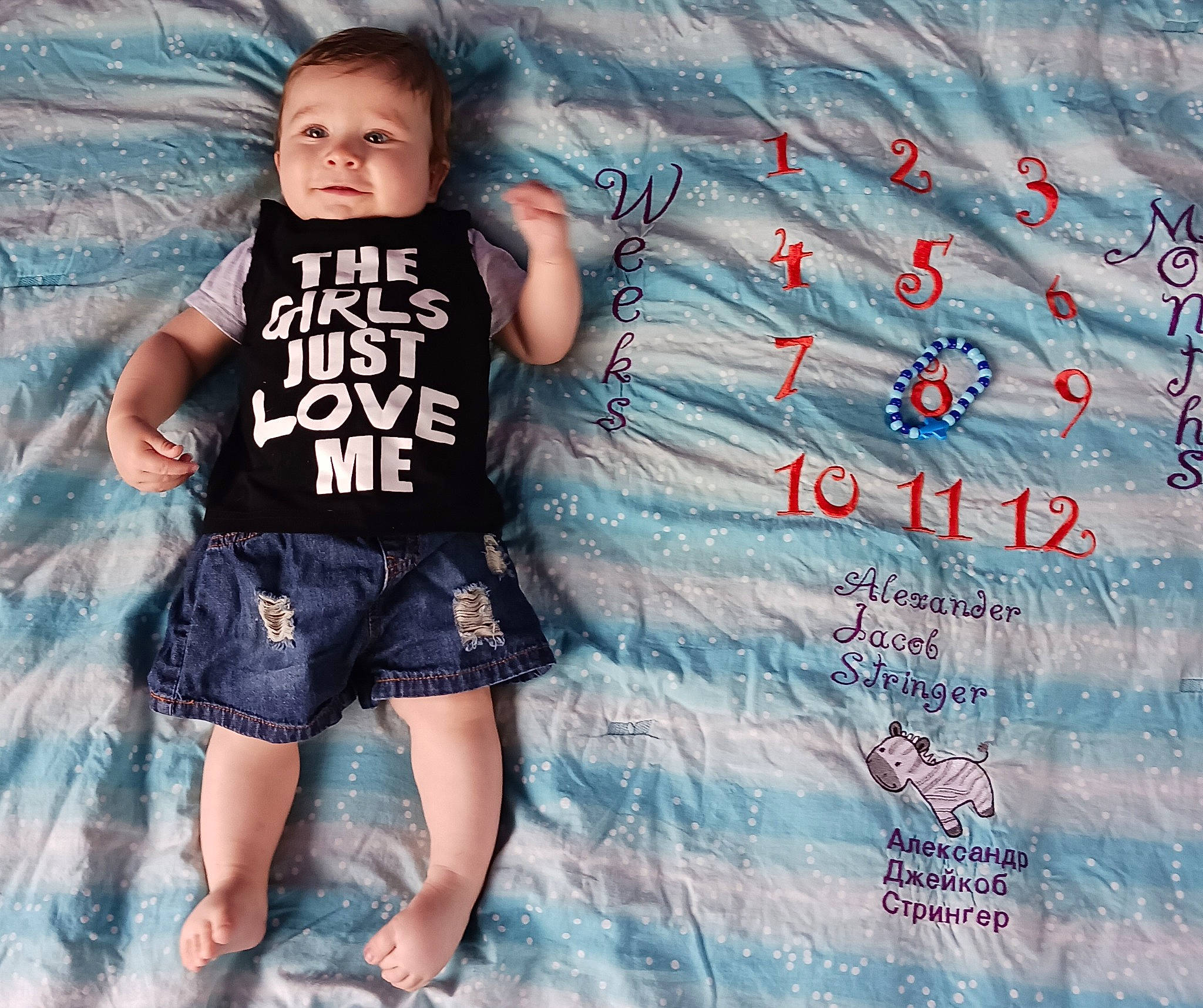 Alexander is registered to the contest to win money with this photo: aqua, azure, baby_toddler_clothing, denim, design, electric_blue, flash_photography, font, happy, pattern, person, pink, product, shorts, sleeve, street_fashion, t_shirt, textile, thigh, toddler