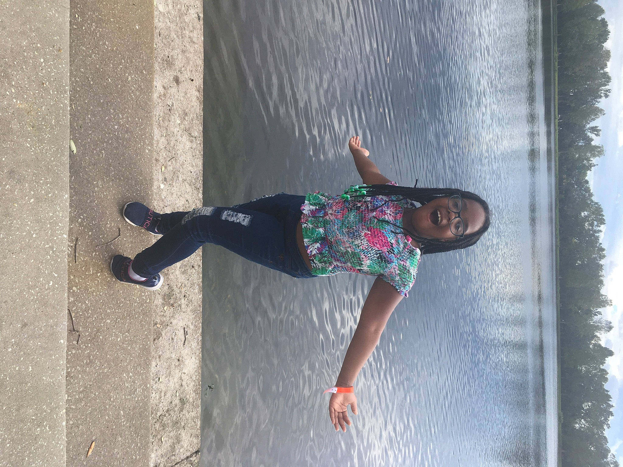 Aamani is registered to the contest to win money with this photo: asphalt, concrete, denim, fun, grey, human_leg, leg, leisure, person, recreation, road_surface, shadow, sidewalk, sky, smile, t_shirt, thigh, waist, walking_shoe, wall