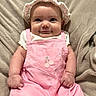 baby, child, infant, portrait, smiling, face, eyes, bonnet, headband, pink_overalls, clothing, cherries, sitting, blanket, cozy, indoors, close_up, adorable, fashion, photography