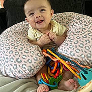 Oakley joined the competition — help win amazing prizes! baby, infant, smiling, boppy_pillow, leopard_print, toy_keys, colorful_toys, sitting, living_room, couch, blanket, hands, feet, portrait, cute, happy, indoor, face, closeup, playtime