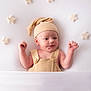 Elio participe au concours pour gagner de l'argent avec cette photo : baby, infant, hat, knitwear, overalls, stars, soft, white_background, cute, newborn, sleepwear, child, portrait, fingers, raised_hands, cozy, lying_down, decor, warm_colors, adorable