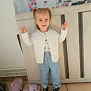 Nora participe au concours pour gagner de l'argent avec cette photo : basket, cabinet, cardigan, child, floor_tiles, framed_photo, happy, home_interior, indoor, person, photograph, pigtails, playful, portrait, slippers, smile, sneakers, striped_pants, toddler, toys