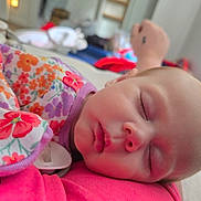 Terrilyn is registered to the contest to win money with this photo: baby, candid, child, closeup, comfort, cute, face, floral_clothing, hand, head, indoors, infant, pacifier, peaceful, person, portrait, rest, skin, sleeping, soft_lighting