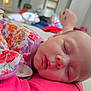 baby, candid, child, closeup, comfort, cute, face, floral_clothing, hand, head, indoors, infant, pacifier, peaceful, person, portrait, rest, skin, sleeping, soft_lighting