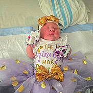 Terrilyn joined the competition — help win amazing prizes! newborn, baby, sleeping, tutu, bow, purple, gold, polka_dot, mittens, headband, hospital, bed, blanket, clothing, person, infant, cute, resting, soft, toddler