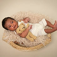 Lucas is registered to the contest to win money with this photo: baby, infant, teddy_bear, knitted_toy, wooden_bowl, fluffy_blanket, cute, child, portrait, soft_lighting, cozy, newborn, sleepwear, relaxed, small_feet, baby_clothing, indoor, studio, adorable, peaceful