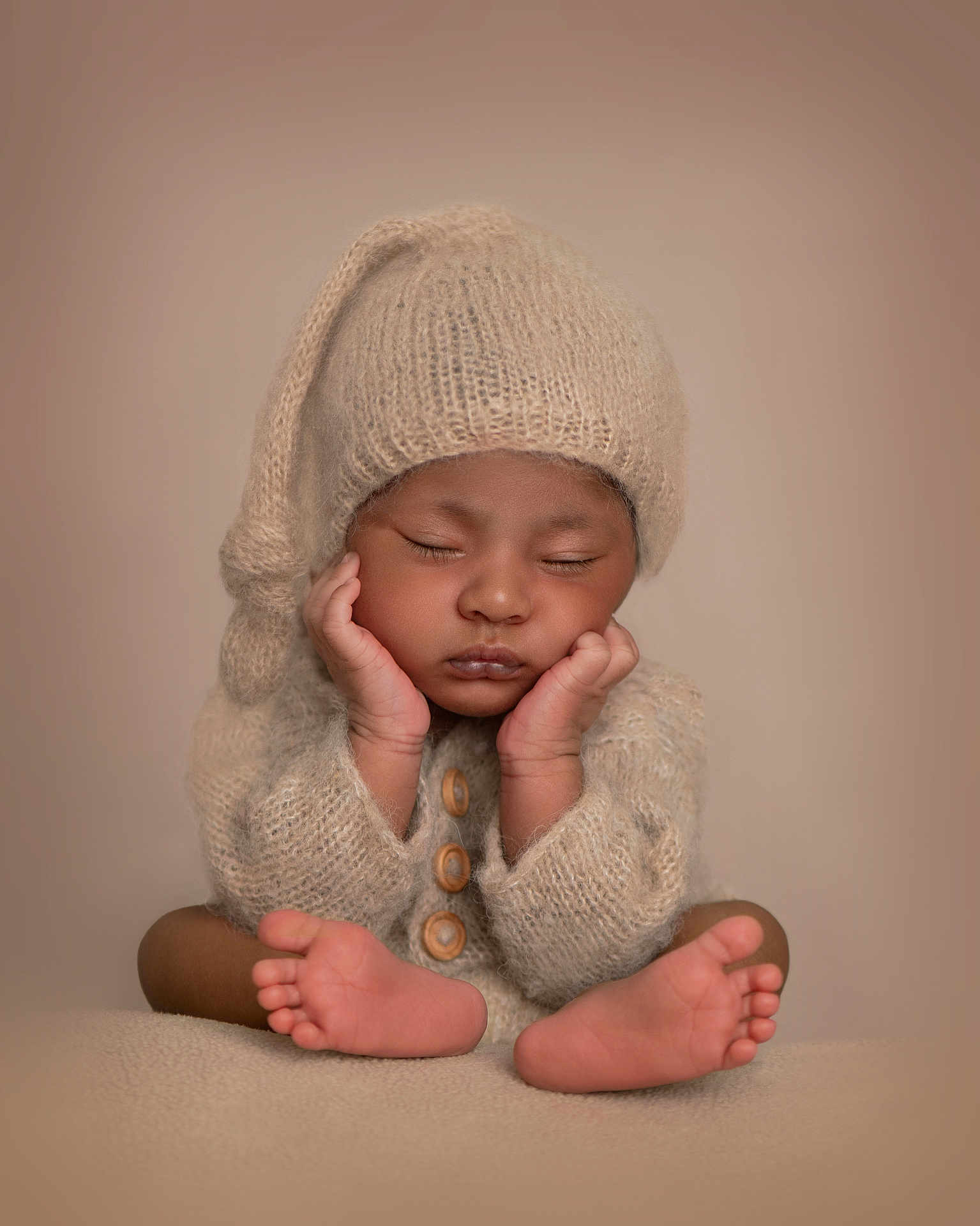 Lucas is registered to the contest to win money with this photo: baby, infant, sleeping, knitted_hat, knitted_sweater, cozy, cute, peaceful, portrait, hands_on_cheeks, tiny_feet, soft_lighting, warm_colors, close_up, child, newborn, studio_photo, neutral_background, adorable, resting