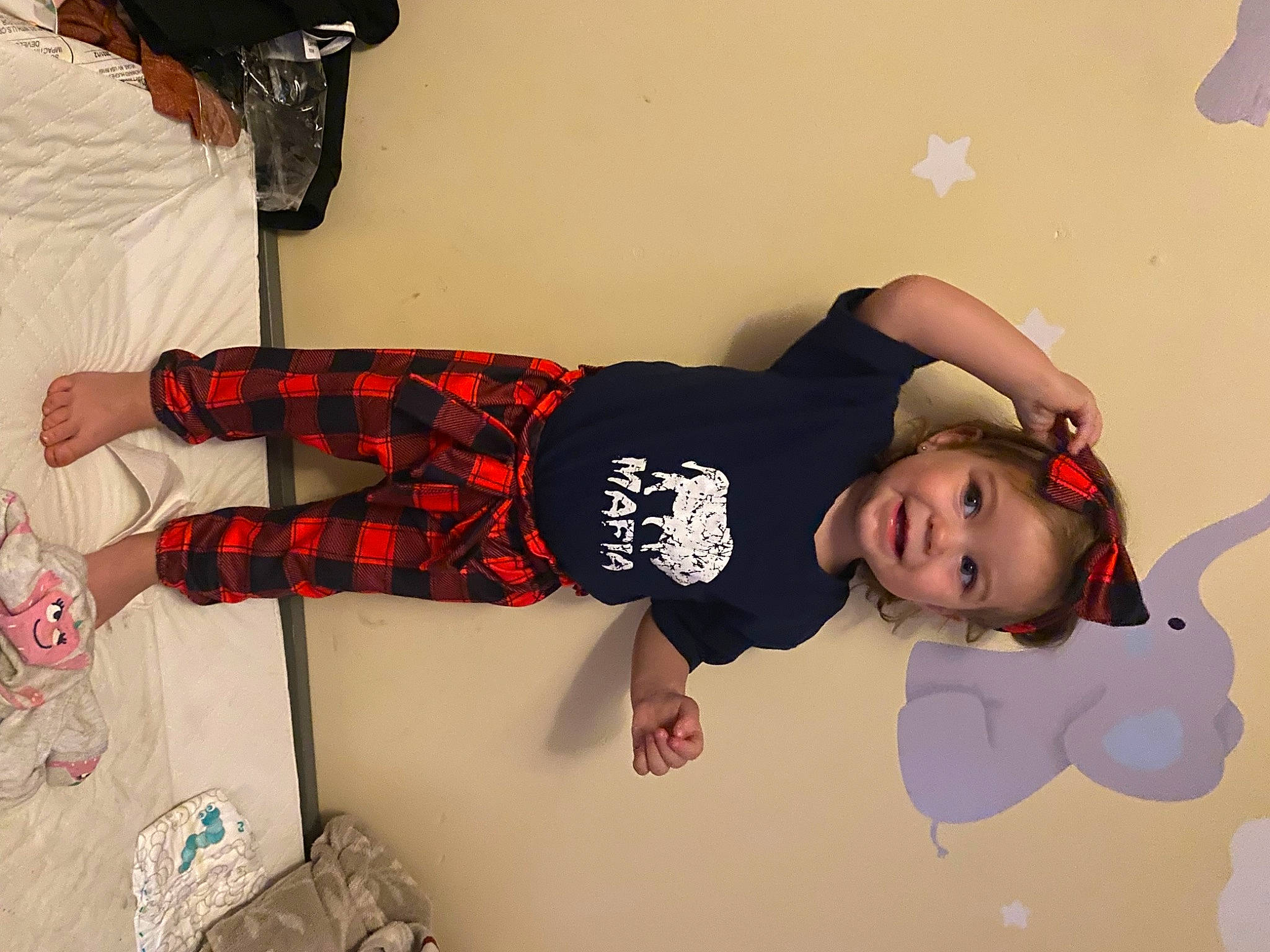 Mckenzie is registered to the contest to win money with this photo: baby, baby_toddler_clothing, carmine, child, flooring, fun, happy, human_leg, joy, knee, pattern, person, personal_protective_equipment, plaid, room, sleeve, sock, sports_gear, sportswear, t_shirt