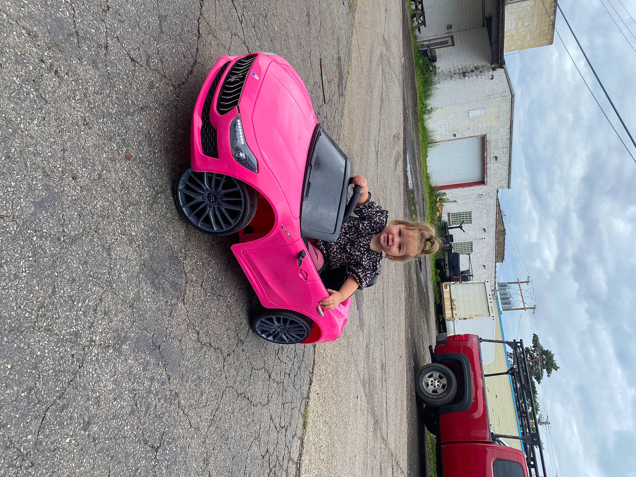 Mckenzie is registered to the contest to win money with this photo: asphalt, automotive_design, automotive_exterior, automotive_lighting, automotive_tire, bumper, car, cloud, fender, hood, joy, motor_vehicle, person, road_surface, rolling, sky, tints_and_shades, tire, vehicle, vehicle_door