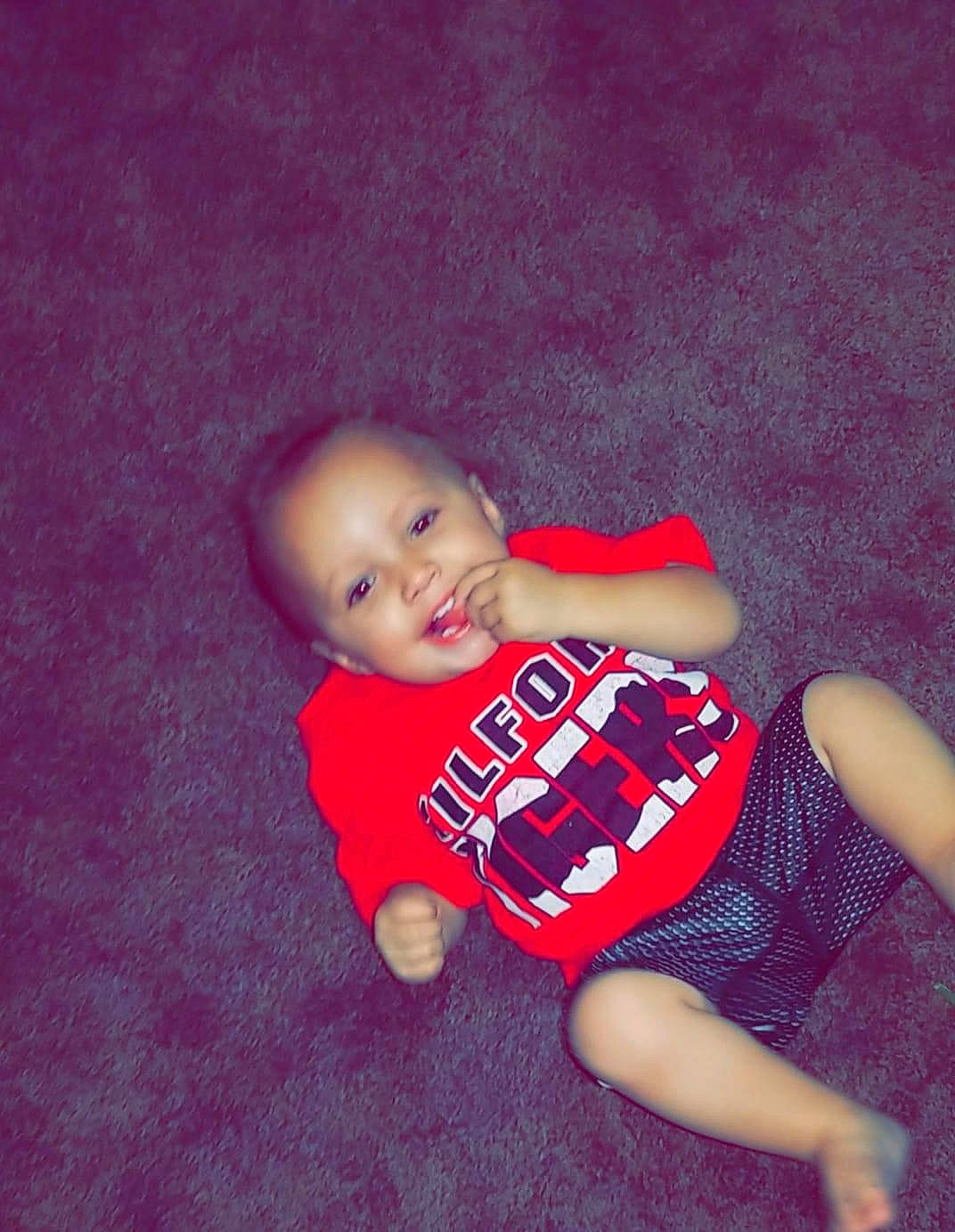 Hendrix is registered to the contest to win money with this photo: arm, baby, baby_toddler_clothing, elbow, electric_blue, flash_photography, floor, flooring, happy, human_body, human_leg, joy, knee, leg, person, sleeve, sportswear, t_shirt, thigh, toddler