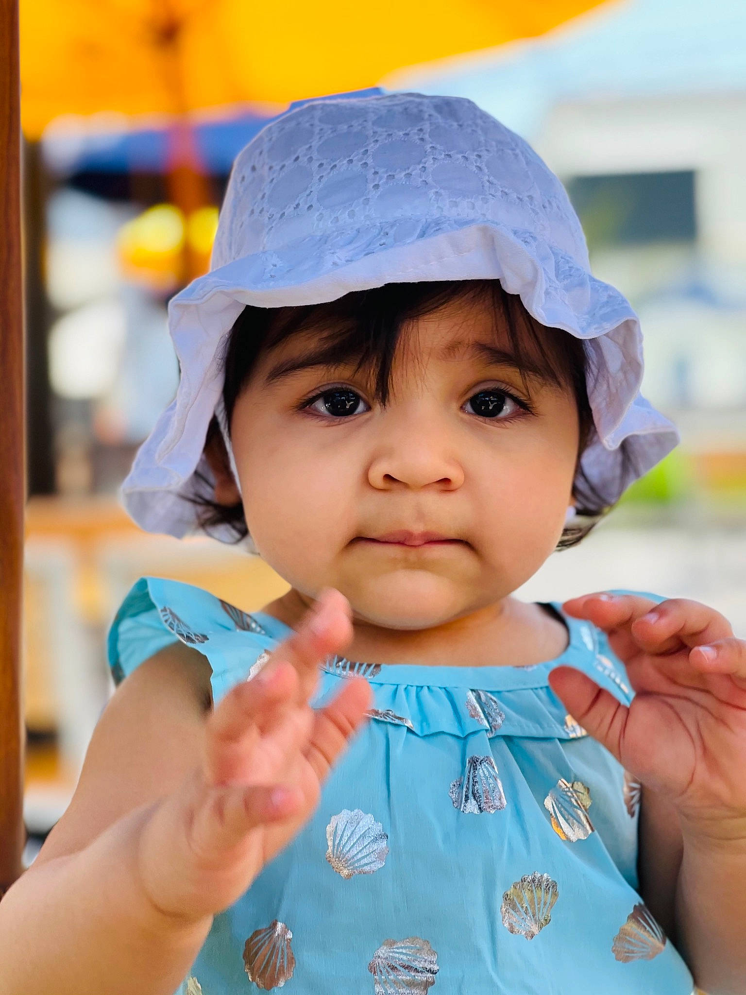 Aisha is registered to the contest to win money with this photo: azure, baby, baby_toddler_clothing, cap, child, face, finger, fun, gesture, hand, happy, hat, headwear, lip, nose, person, photograph, pink, skin, sleeve