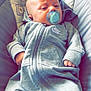 Archie joined the competition — help win amazing prizes! baby, infant, pacifier, onesie, nike, gray_clothing, cushion, seat, cute, animal_print, comfort, relaxed, child, young, small_hands, portrait, indoors, casual, soft_lighting, babywear