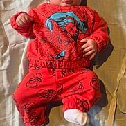 Archie joined the competition — help win amazing prizes! baby, infant, child, spiderman_outfit, red_clothing, tongue_out, blanket, lying_down, white_socks, pacifier, carpet, cute, playful, indoors, soft_lighting, portrait, young_child, face, hands, feet