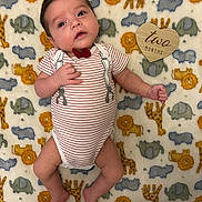 Thomas joined the competition — help win amazing prizes! baby, infant, blanket, animal_pattern, onesie, striped_clothing, bow_tie, wooden_sign, heart_shape, milestone, cute, lying_down, portrait, child, young_baby, soft_texture, colorful, decorative, indoor, face