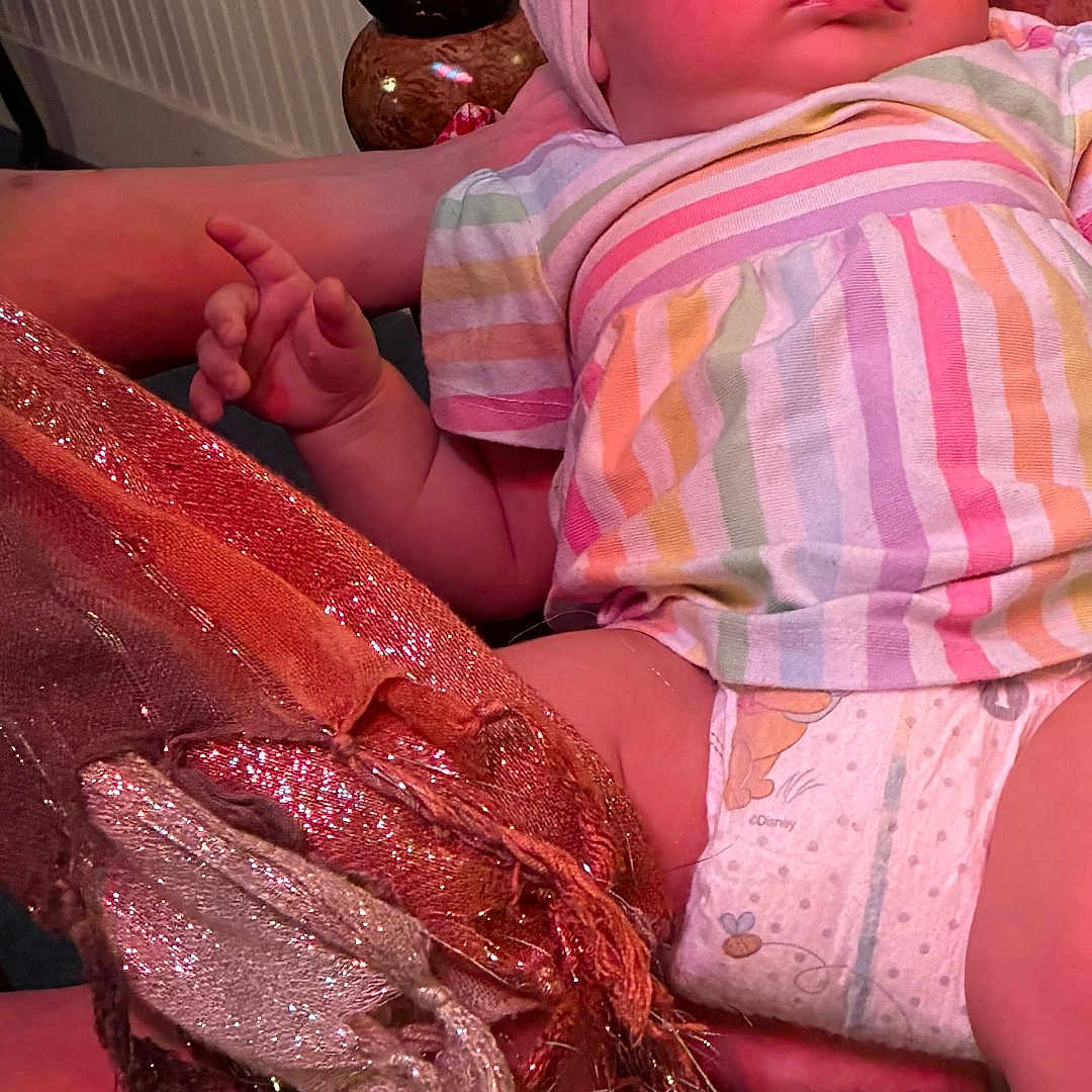 Ava is registered to the contest to win money with this photo: baby, bow, child, closeup, cozy, curious, cute, diaper, fabric, face, hand, headband, indoor, infant, person, sock, soft, sparkle, striped_shirt, texture