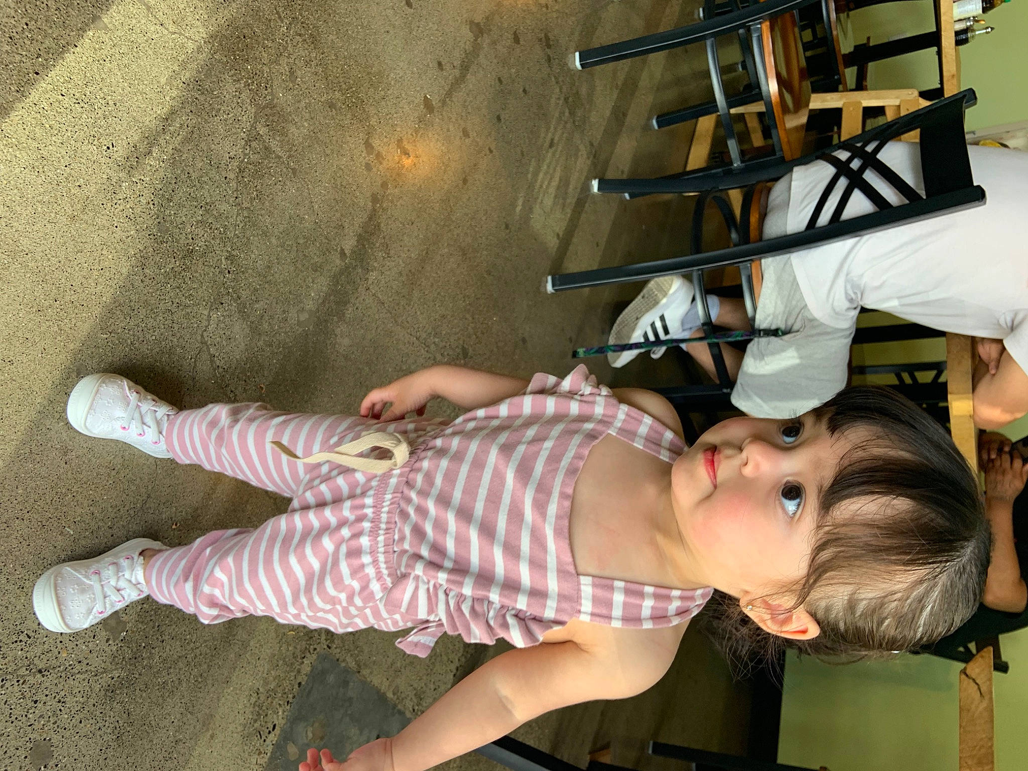 Melani joined the competition — help win amazing prizes! baby_toddler_clothing, chair, child, elbow, foot, fun, human_leg, knee, leg, leisure, pattern, person, room, sandal, sock, thigh, toddler, white
