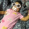 Isla Anani joined the competition — help win amazing prizes! baby, child, pacifier, sunglasses, pink_onesie, butterflies, blanket, patterned_blanket, curly_hair, infant, cute, lying_down, indoors, relaxed, accessory, fashion, sleepwear, comfort, person, portrait