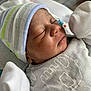 Carlos Jr joined the competition — help win amazing prizes! newborn, baby, sleeping, hat, mittens, blanket, closeup, face, peaceful, infant, soft, cozy, clothing, portrait, child, resting, cute, tiny, newborn_clothes, indoors