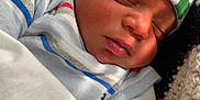 Carlos Jr is registered to the contest to win money with this photo: baby, newborn, sleeping, hat, colorful, striped, clothing, blanket, knitted, face, peaceful, infant, cute, soft, resting, portrait, child, warm, cozy, indoors