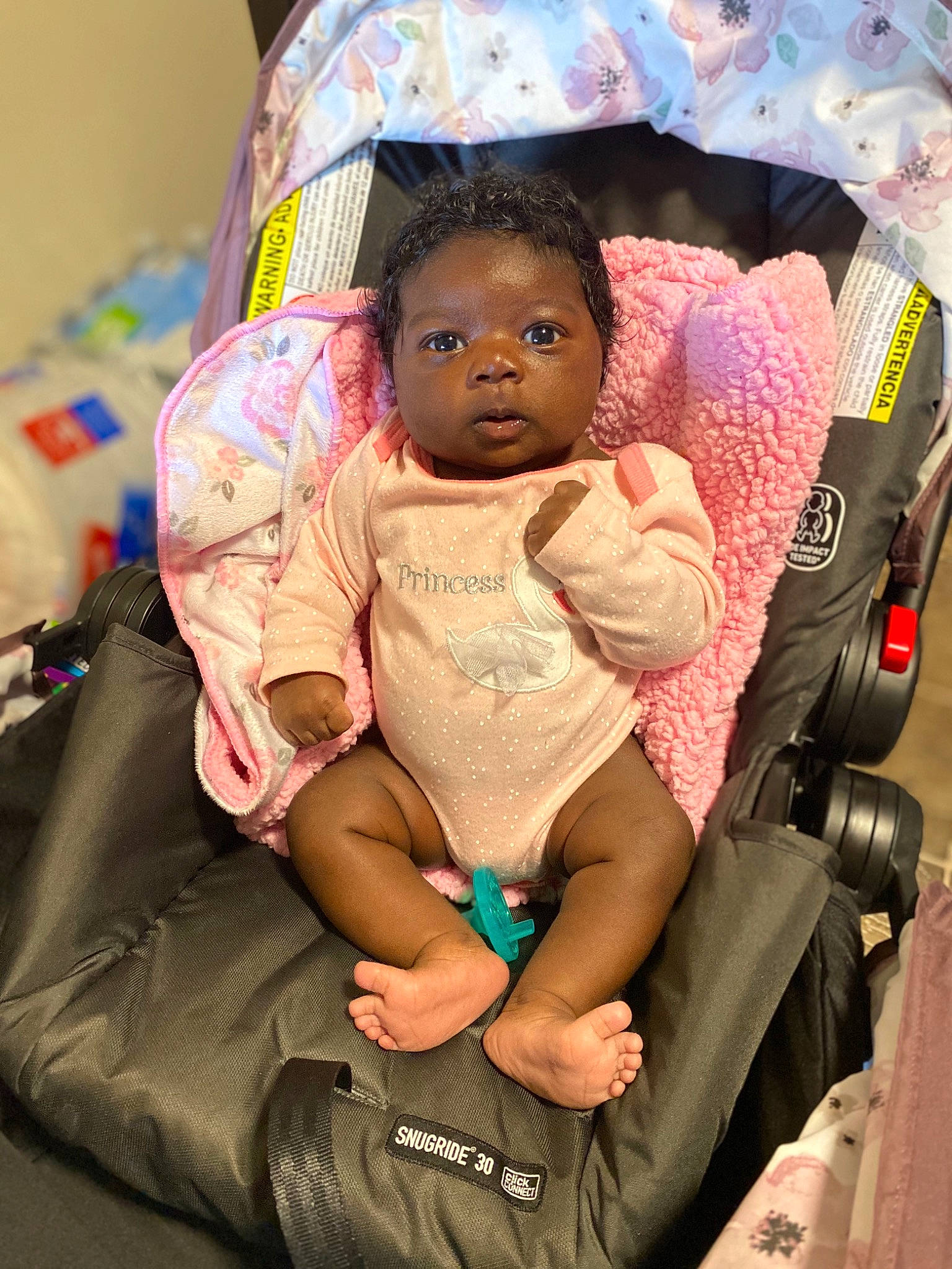 Jaelyn is registered to the contest to win money with this photo: arm, baby, baby_carriage, baby_products, bag, car_seat, chair, cheek, comfort, eye, finger, fun, hand, happy, human_body, mouth, person, pink, skin, thigh