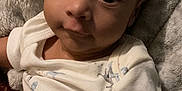 Liam is registered to the contest to win money with this photo: baby, blanket, bodypart, clothing, cushion, face, finger, furniture, hand, happy, head, homedecor, newborn, person, photography, portrait, quilt, sitting, smile, t_shirt