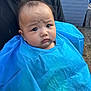 baby, child, blue_cape, portrait, outdoor, person, face, expression, curious, black_shirt, brick_wall, head, skin, hair, young, cute, holding, closeup, infant, people