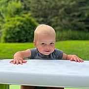 William joined the competition — help win amazing prizes! toddler, child, smiling, outdoor, table, bench, grass, green, nature, playful, happy, face, feet, hands, summer, daylight, park, casual_clothing, cute, portrait
