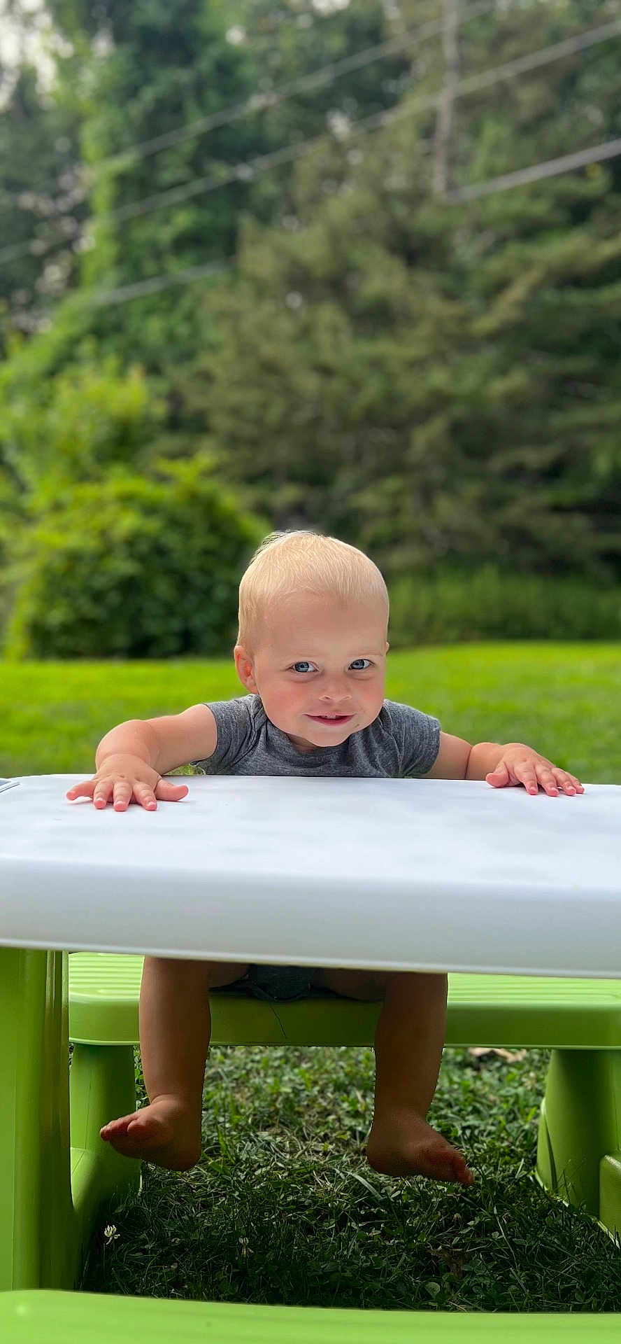 William joined the competition — help win amazing prizes! toddler, child, smiling, outdoor, table, bench, grass, green, nature, playful, happy, face, feet, hands, summer, daylight, park, casual_clothing, cute, portrait