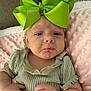 Wrenlee joined the competition — help win amazing prizes! baby, infant, green_bow, headband, pout, blanket, pink_blanket, onesie, clothing, face, eyes, hands, couch, texture, portrait, close_up, adorable, newborn, expression, headwear