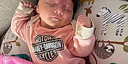 Wrenlee is registered to the contest to win money with this photo: baby, sleeping, bow, headband, onesie, harley_davidson_logo, pink_blanket, pillow, zebra_illustration, sloth_illustration, couch, cozy, nursery, soft_texture, closed_eyes, peaceful, hand, tiny_hand, newborn, portrait