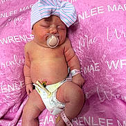 Wrenlee is registered to the contest to win money with this photo: baby, newborn, infant, pacifier, bow_hat, diaper, umbilical_clamp, wristband, blanket, pink, sleeping, hospital, cozy, chubby_cheeks, legs, belly_button, skin, closeup, laying_down, cute