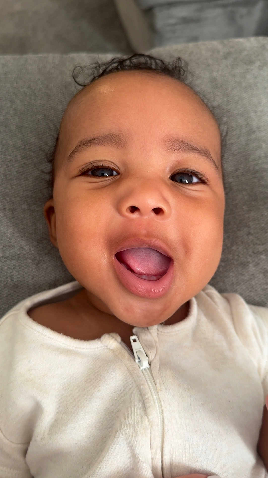 Amari-Jaicob joined the competition — help win amazing prizes! baby, close_up, face, smiling, mouth_open, eyes, infant, child, white_clothing, zipper, skin, expression, cute, young, portrait, indoor, soft_texture, happy, person, head