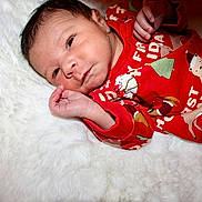 Isaac joined the competition — help win amazing prizes! baby, infant, newborn, pajamas, red_clothing, polar_bear, christmas_tree, holiday_theme, blanket, white_fur, cute, lying_down, hand, face, skin, sleepwear, cozy, portrait, indoors, child