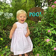 Indigo joined the competition — help win amazing prizes! child, toddler, dress, barefoot, garden, flowers, greenery, plants, tree, wooden_sign, outdoor, happy, smiling, nature, summer, daylight, leaves, path, wood, pink