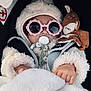 baby, child, pacifier, sunglasses, plush_toy, blanket, coat, winter_clothing, hood, hand, infant, face, cute, soft_texture, car_seat, cozy, warm, sleepy, accessory, toy