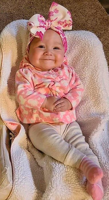 Maleigha is registered to the contest to win money with this photo: baby, baby_toddler_clothing, beige, cheek, child, design, headgear, headwear, joy, outerwear, pattern, person, pink, product, skin, smile, textile, toddler
