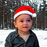 Liano participe au concours pour gagner de l'argent avec cette photo : toddler, child, santa_hat, denim_shirt, winter, snow, forest, outdoor, portrait, cute, holiday, christmas, seasonal, young_child, smiling, winter_clothing, face, headwear, snowfall, nature