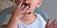 Liano participe au concours pour gagner de l'argent avec cette photo : toddler, child, messy, chocolate, plate, high_chair, food, eating, face, hands, happy, cute, indoor, white_shirt, table, smudged, delicious, baby, fun, closeup