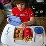 Noah joined the competition — help win amazing prizes! appliance, cabinet, chicken_nuggets, child, curly_hair, flooring, food_container, french_fries, high_chair, indoor, ketchup, meal, nike, person, pikachu, red_shirt, snack, stickers, tablet, tray