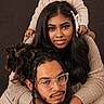baby, woman, man, family, portrait, smiling, happy, cozy, clothing, sweater, people, human_pyramid, studio_photo, brown_background, glasses, hair, hands, face, closeup, indoor