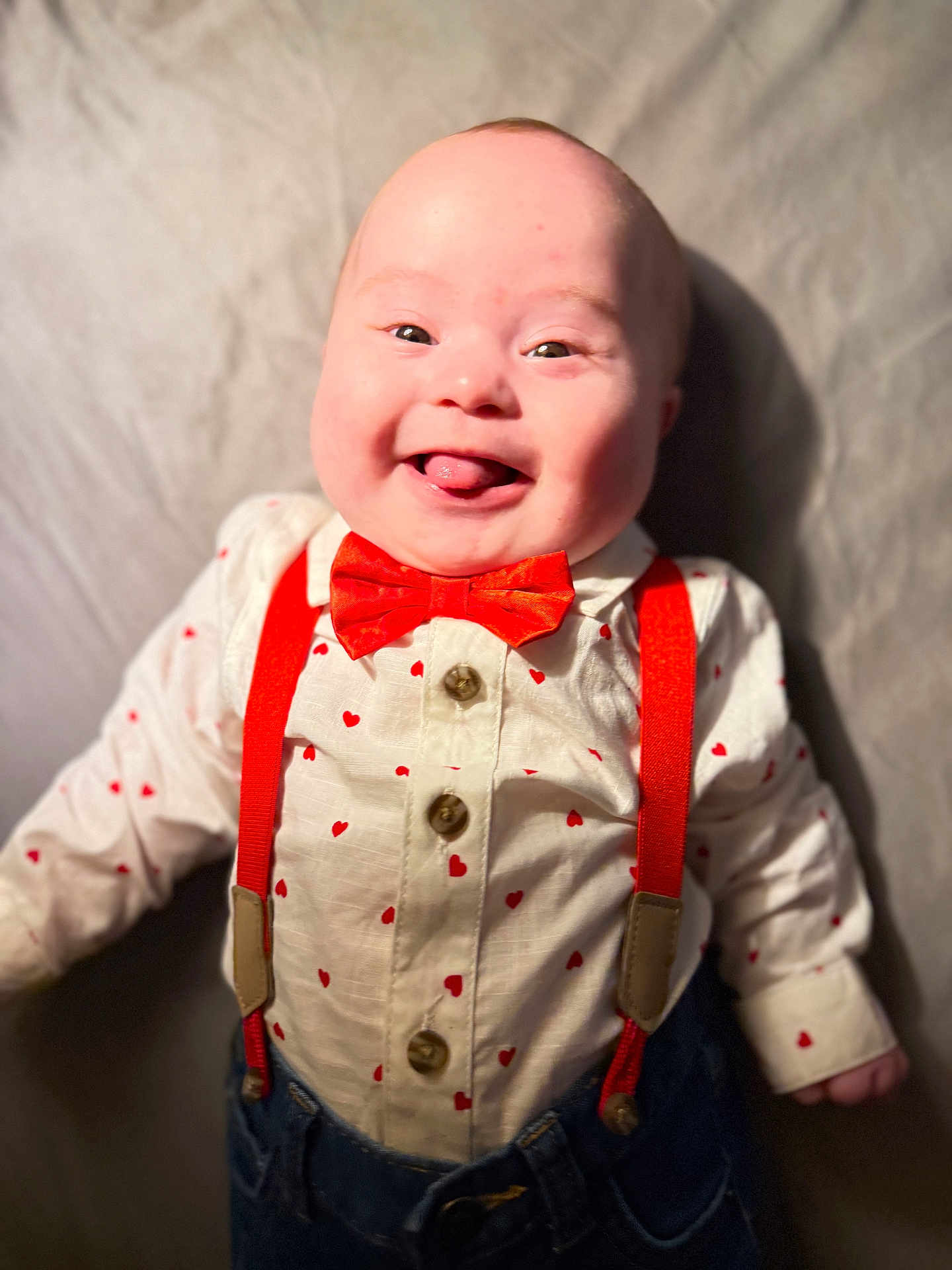 Kazmier Finn joined the competition — help win amazing prizes! baby, smiling, tongue_out, red_bow_tie, red_suspender, heart_pattern, white_shirt, denim_pants, cute, portrait, infant, happy, child, indoor, clothing, fashion, face, person, closeup, playful