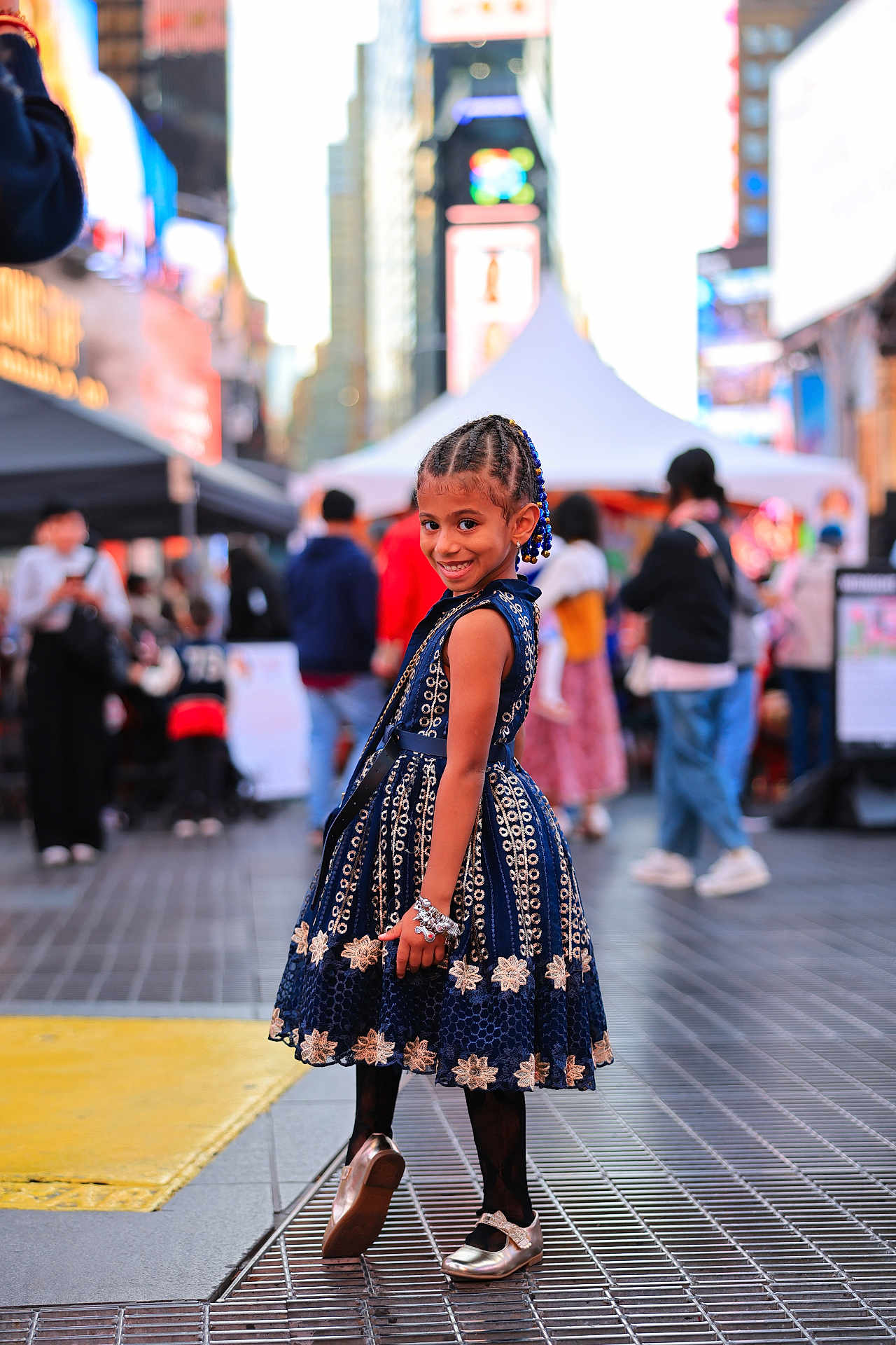 Wynter joined the competition — help win amazing prizes! child, girl, smiling, dress, braided_hair, bracelet, urban, street, city, people, crowd, footwear, posing, fashion, daylight, side_view, outdoor, happy, background_blur, public_place
