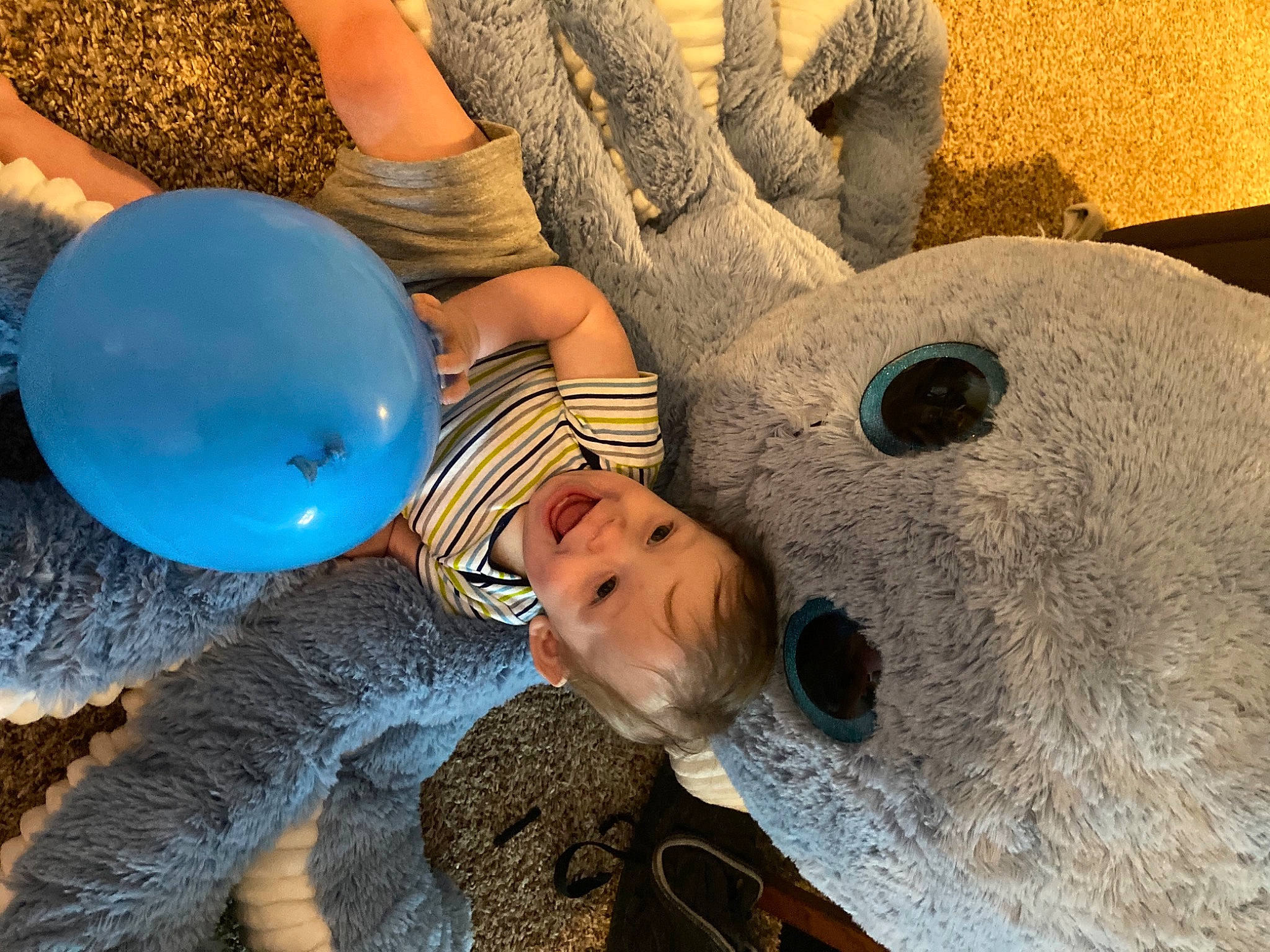 Axl is registered to the contest to win money with this photo: automotive_wheel_system, balloon, child, circle, concrete, electric_blue, fun, happy, hat, headgear, human_leg, joy, leisure, organism, party_supply, person, personal_protective_equipment, play, recreation, toddler