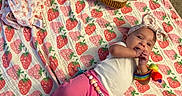 Amira joined the competition — help win amazing prizes! baby, blanket, strawberry_pattern, headband, plush_toy, peanut_butter_toast, jelly_toast, pink_pants, white_shirt, wrist_rattle, carpet, infant, cute, lying_down, indoor, child, playful, soft_toys, colorful, cozy