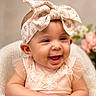 Amira is registered to the contest to win money with this photo: baby, child, smiling, headband, flower, pink_dress, embroidery, cute, happy, portrait, infant, soft_blanket, closeup, indoors, baby_girl, hands, skin, face, cheerful, background_flower