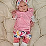 baby, infant, pink_clothing, headband, blanket, white_socks, patterned_shorts, lying_down, indoors, soft_texture, cute, portrait, child, newborn, small_hands, footwear, sleepwear, fabric, resting, comfortable
