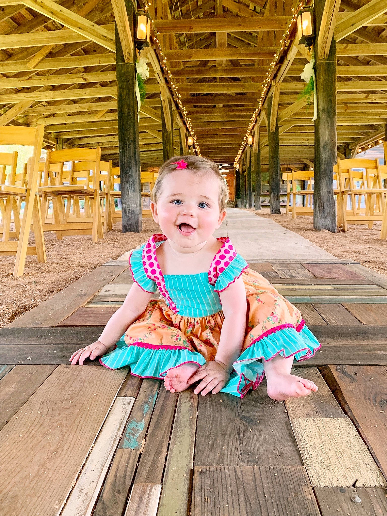 Katherine joined the competition — help win amazing prizes! boardwalk, child, child_model, dress, fashion_accessory, leisure, person, photography, pink, play, sitting, smile, stock_photography, summer, toddler, turquoise, vacation, wood